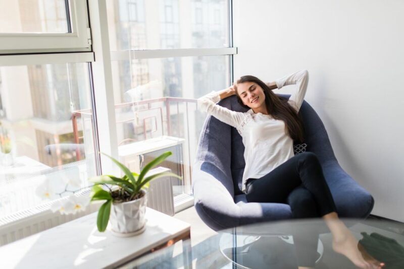 relaxing-woman-sitting-comfortable-sofa-lounge-chair-home-lr-e1775037310811.jpg